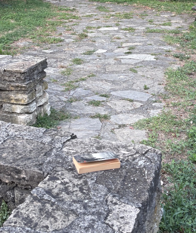 A book lying on a stone seat in the valley of Astino