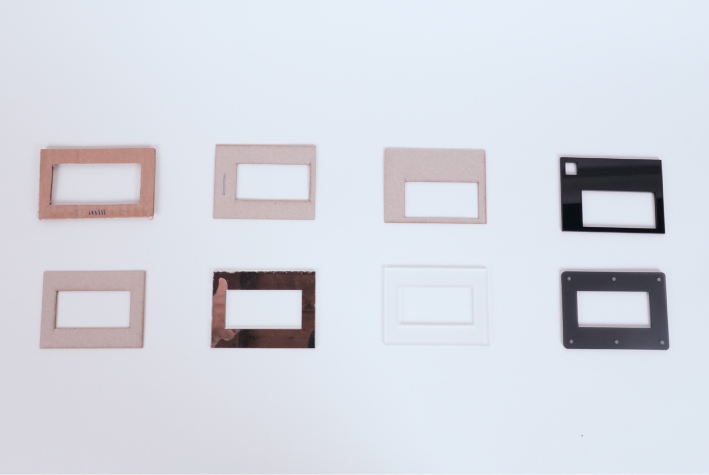 Eight Remora frame prototypes in two rows, in different finishes and with the screen in different places