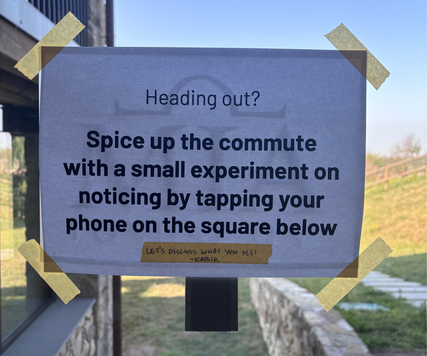 A laminated sign at an exit inviting you to tap your phone on the NFC square below
