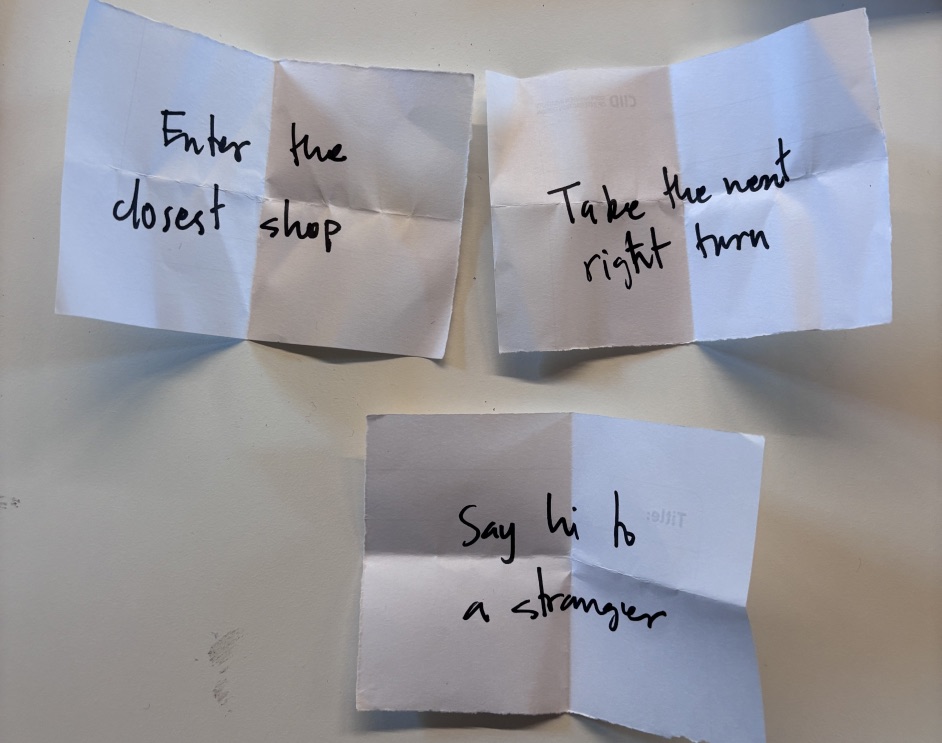 Small folded paper notes with handwritten prompts