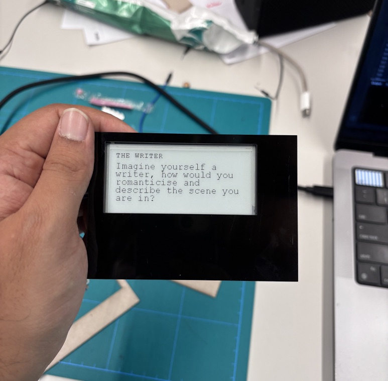 A hand holding an early e-ink display prototype