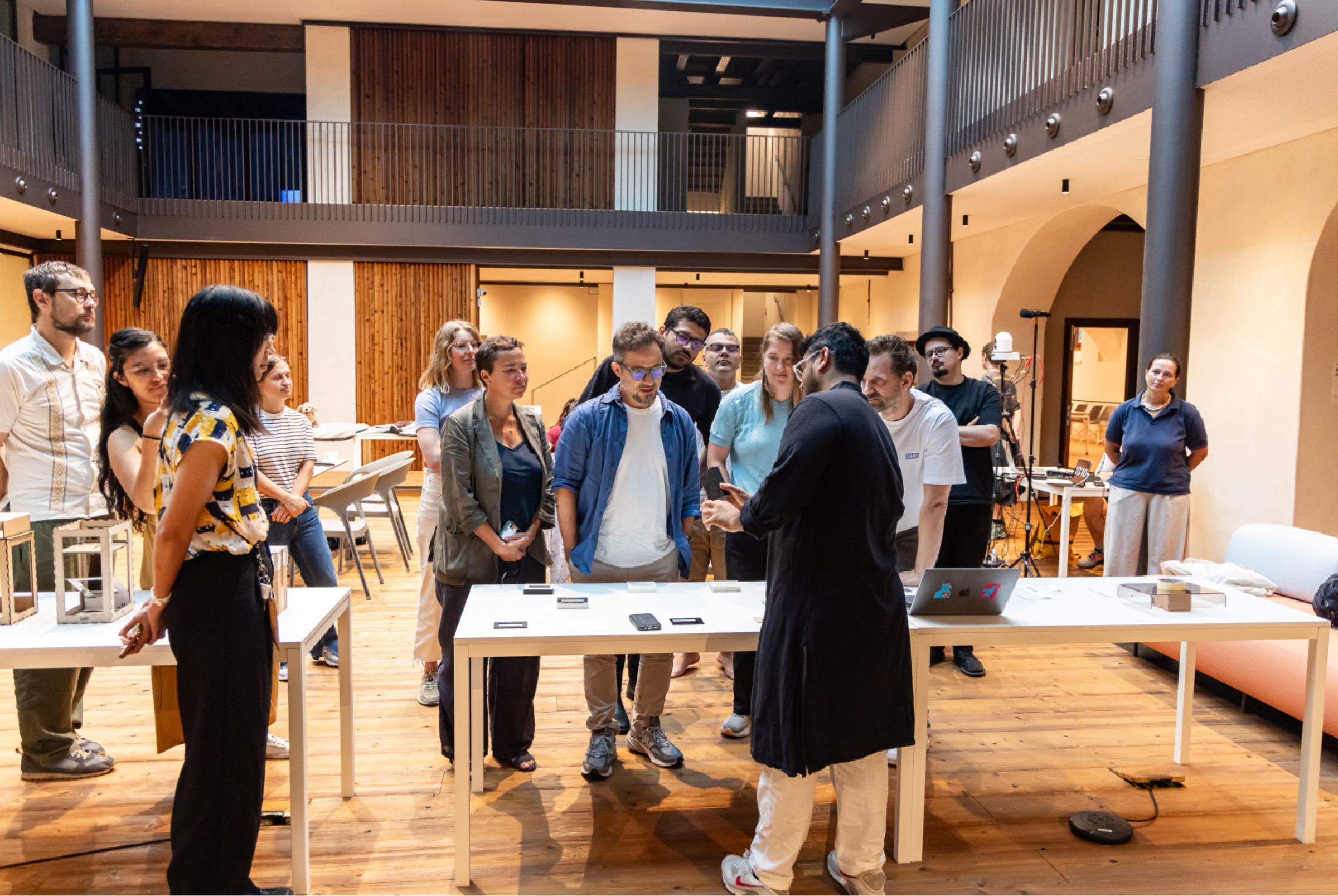 People gathered around tables at the Remora showcase